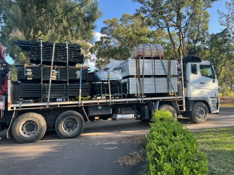 Truck loaded with scaffold equipment for site delivery